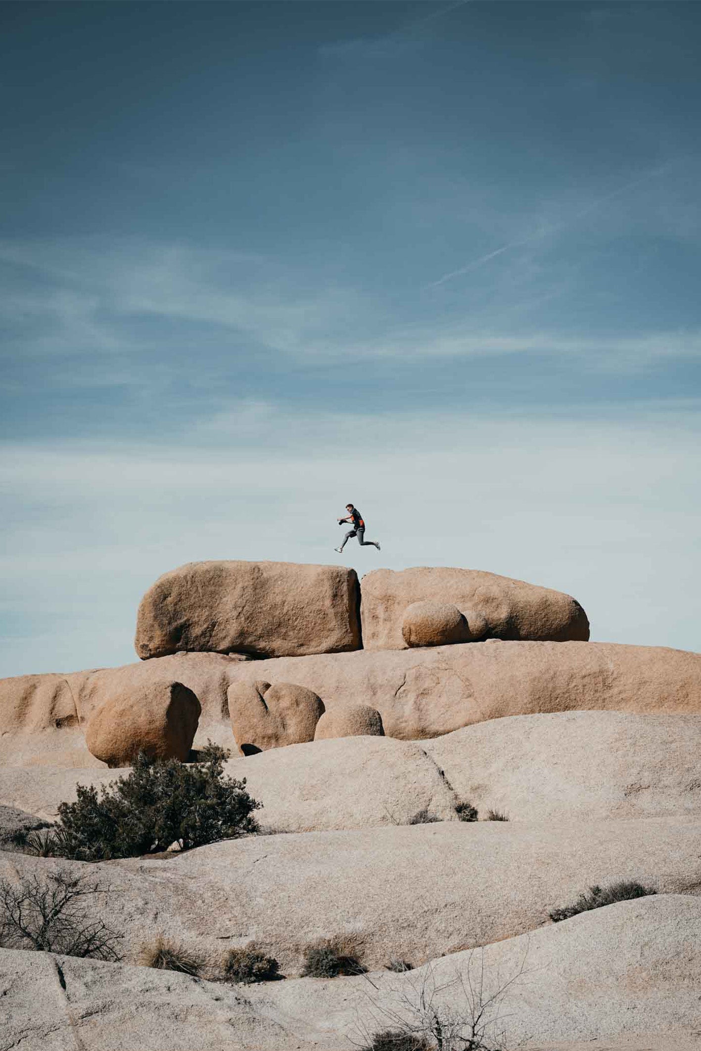 A self-portrait captured by photographer Hannes Kläger, mid-leap between boulders in Joshua Tree, California. Available to buy as a framed, ready-to-hang fine art print.