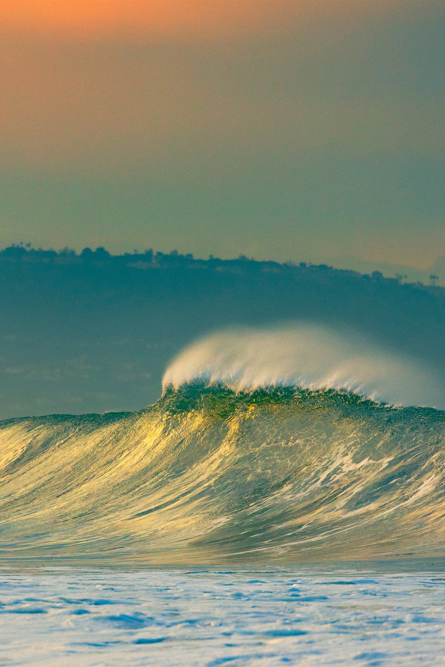 Golden ocean wave at sunrise titled ‘LIME’ by Craig Hubbard, fine art photograph from Manhattan Beach USA with rich color tones and coastal landscape backdrop.