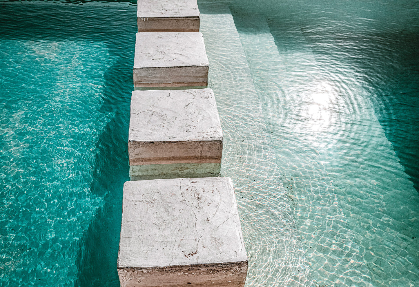 Stepping stones in a clear blue rippling pool - a fine art print by Charles Johnstone available ready-to-hang.