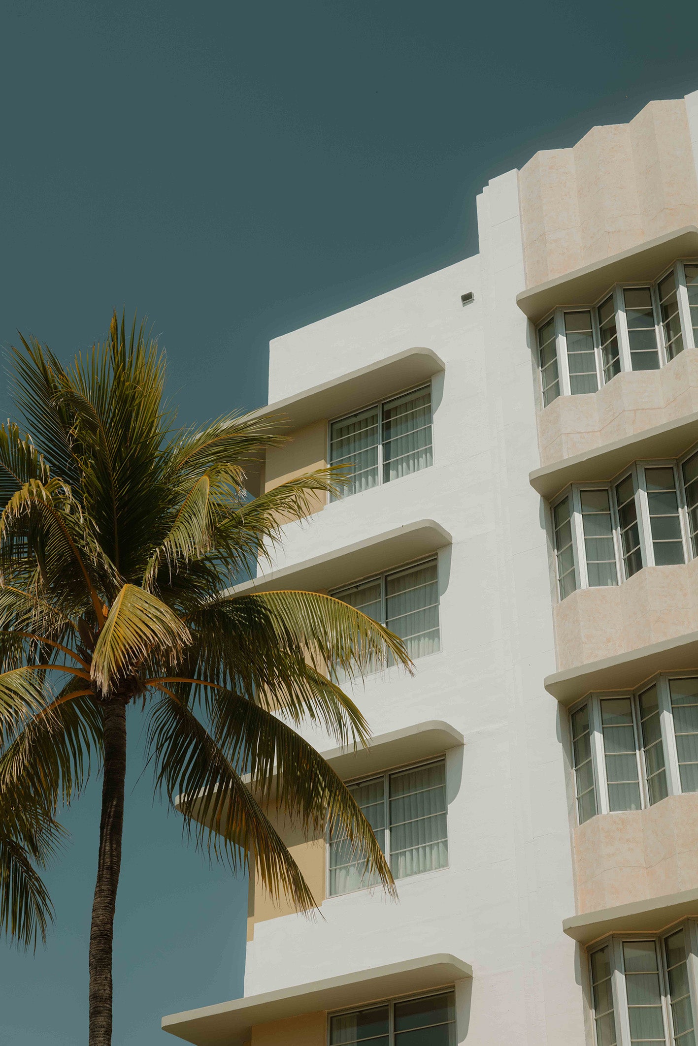 A typical scene in Miami’s Art Deco District, with a palm tree framing a distinctively shaped building with playful architecture. Captured by Hannes Kläger, the fine art print is available to purchase on The Lost Works.
