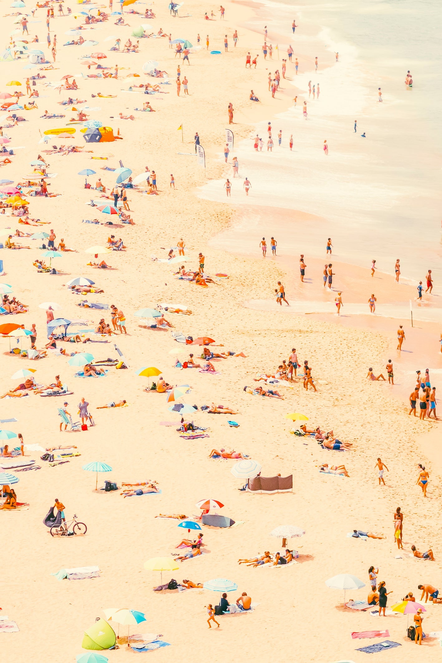 A busy beach day in Ericeira, Portugal. Photograph by Will Bremridge, available to purchase as a framed print exclusively on The Lost Works.