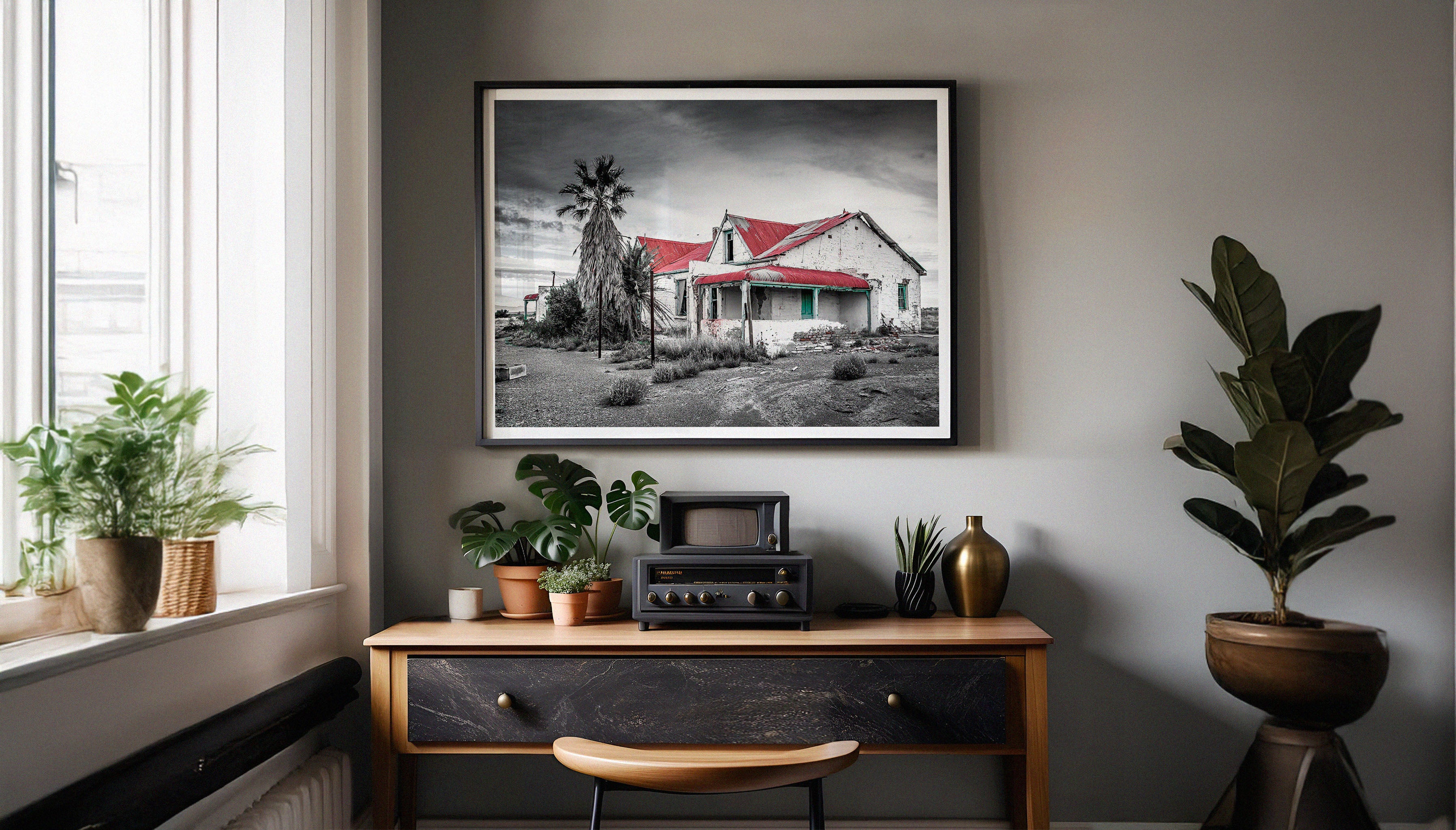 An abandoned farmhouse still stands in the Karoo, with a corrugated red roof and turquoise windows. A striking contrast against the rugged landscape. A fine art photography print by Charles Johnstone, available framed and ready-to-hang on The Lost Works.