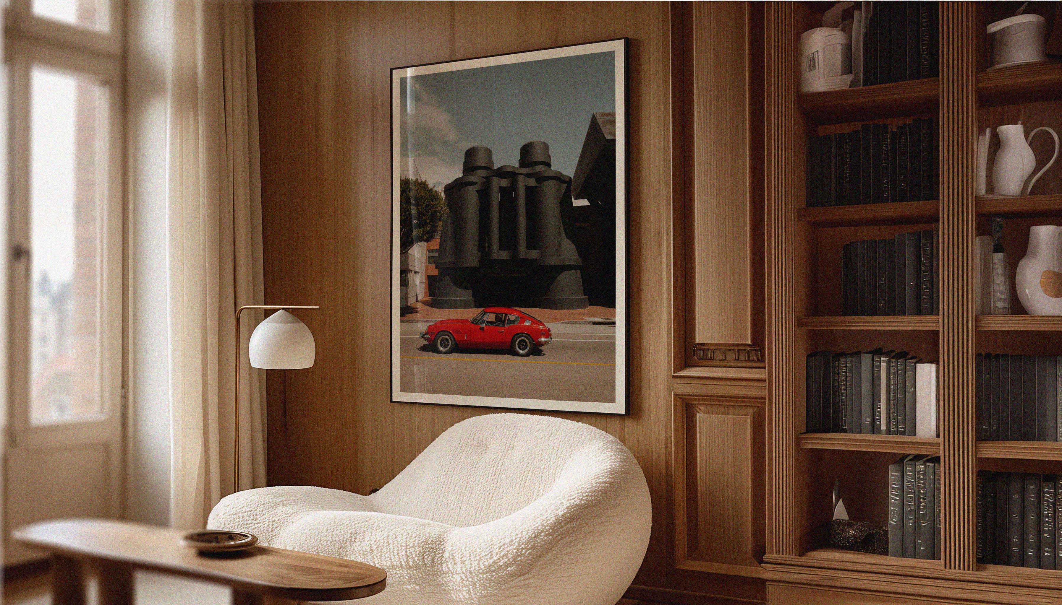 A ready-to-hang framed print by photographer Hannes Kläger, showing the Binoculars Building in Venice Beach, LA with a classic red Triumph GT6 cruising past.
