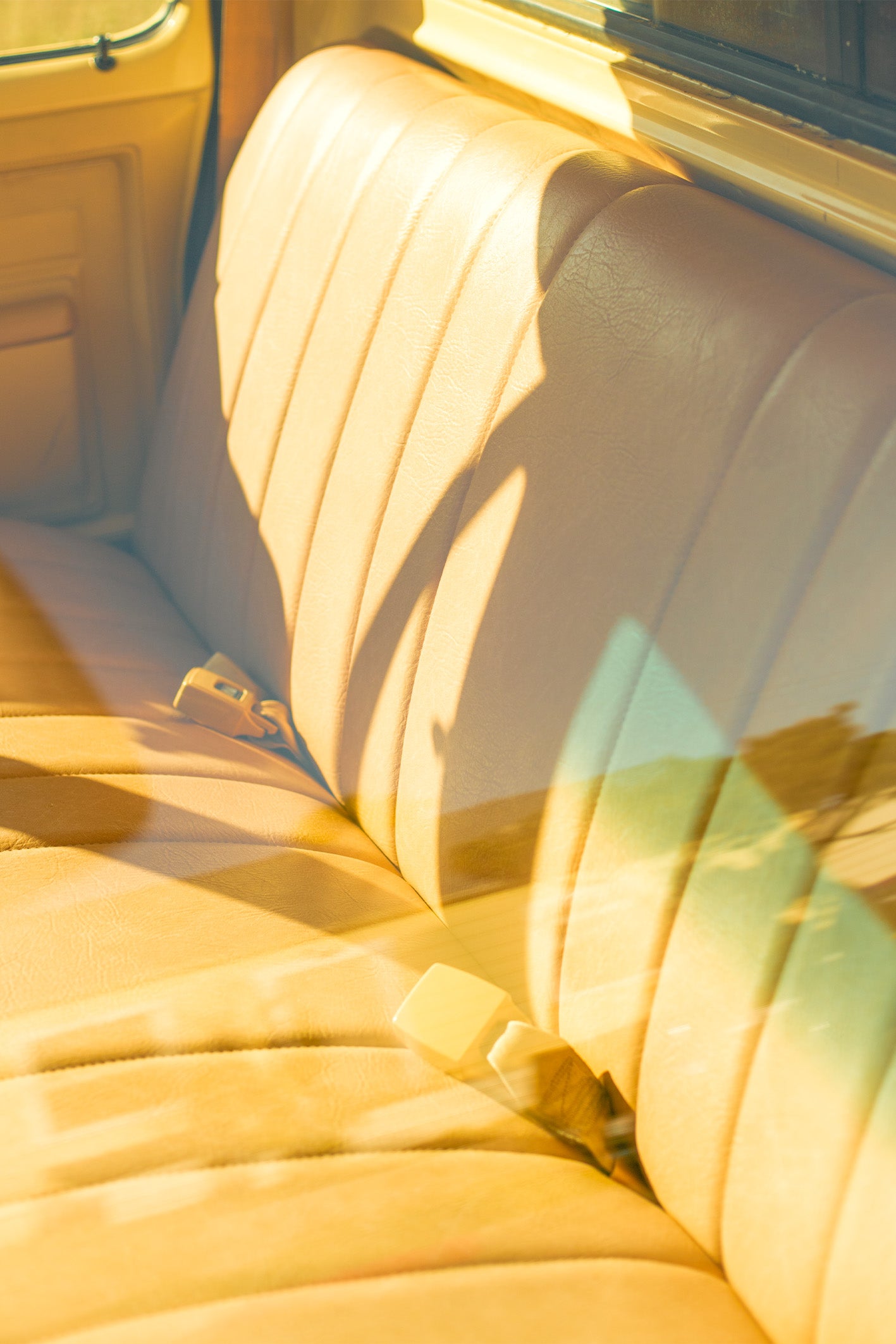 A photograph by Will Bremridge looking through a window into a vintage truck in a laid-back neighbourhood in San Diego. The eye-catching yellow interior combined with the subtle reflection of the blue sky will have you dreaming of warm summer days. Available exclusively as a framed, fine art print at The Lost Works.