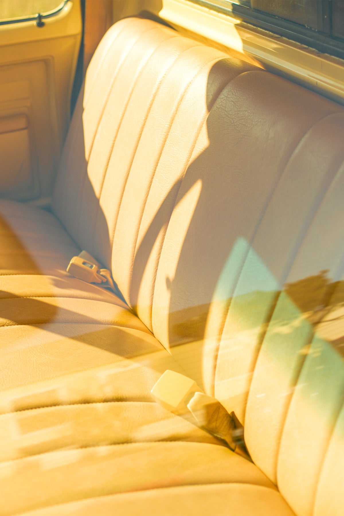A photograph by Will Bremridge looking through a window into a vintage truck in a laid-back neighbourhood in San Diego. The eye-catching yellow interior combined with the subtle reflection of the blue sky will have you dreaming of warm summer days. Available exclusively as a framed, fine art print at The Lost Works.