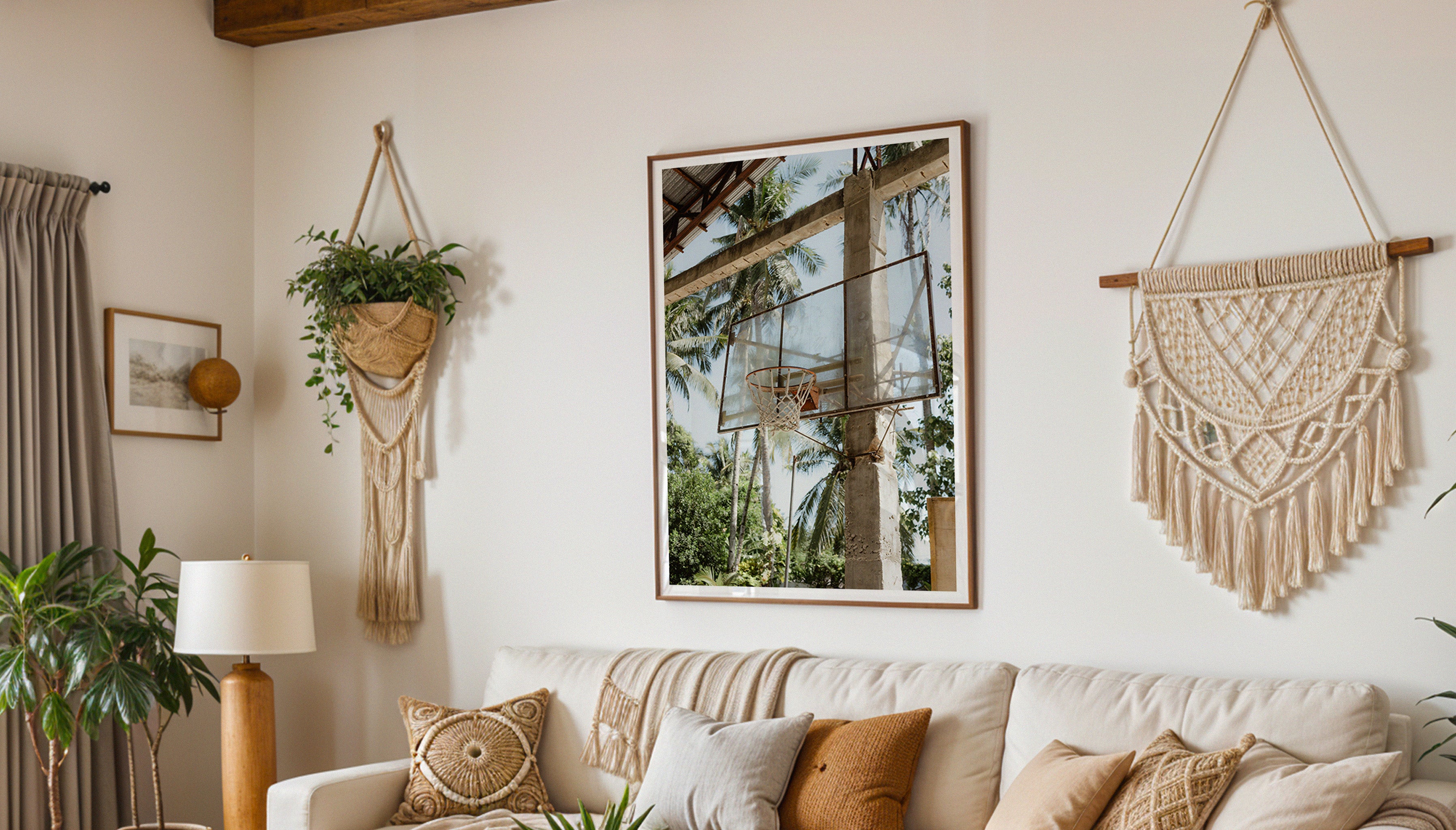 Fine art photography print HOOP by Evie Johnstone, hanging on a wall in a large wooden frame in a boho living room with plants and macrame wall hangings. 