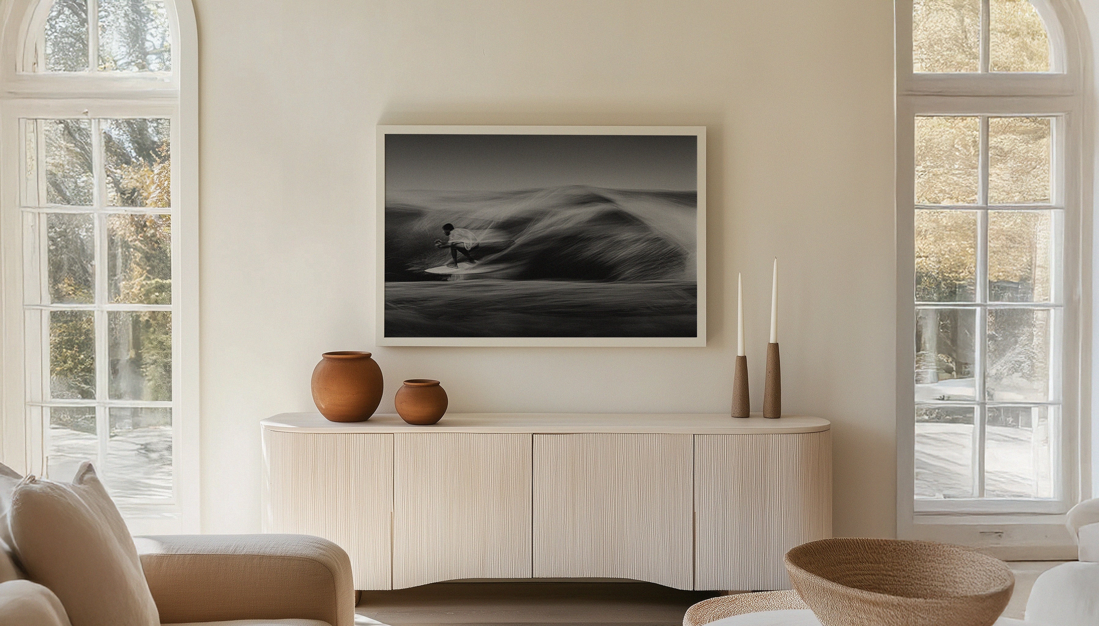 Coastal-inspired living room with a large fine art surf print by Ez Rivero on the wall, highlighting the surfing culture of Santa Teresa.