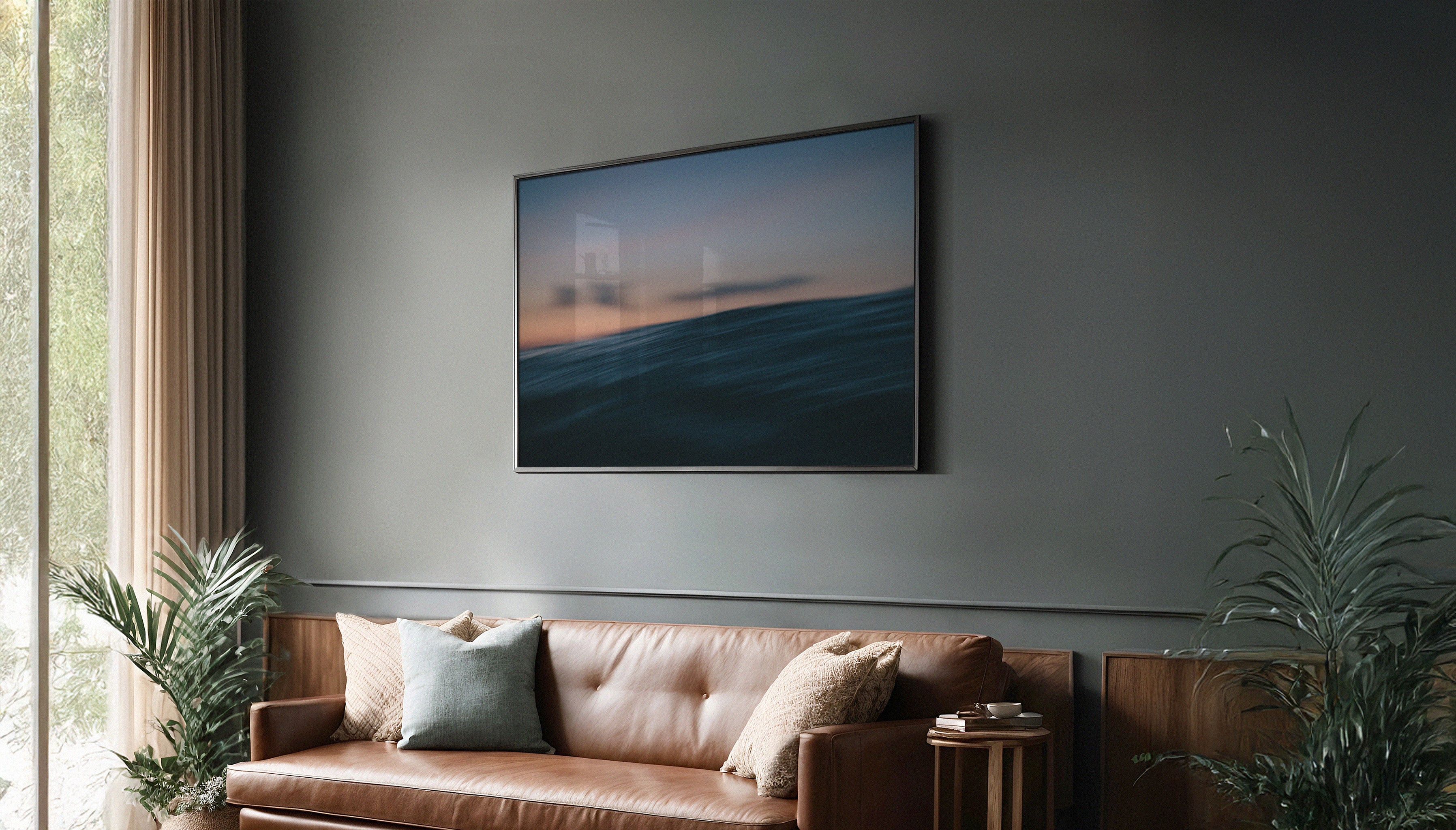 Chris Hall's fine art print hanging framed on a dark wall -  part of The Sunset Journals, the print is of an ocean wave at sunset taken from water level, with soft pastel skies and motion blur.