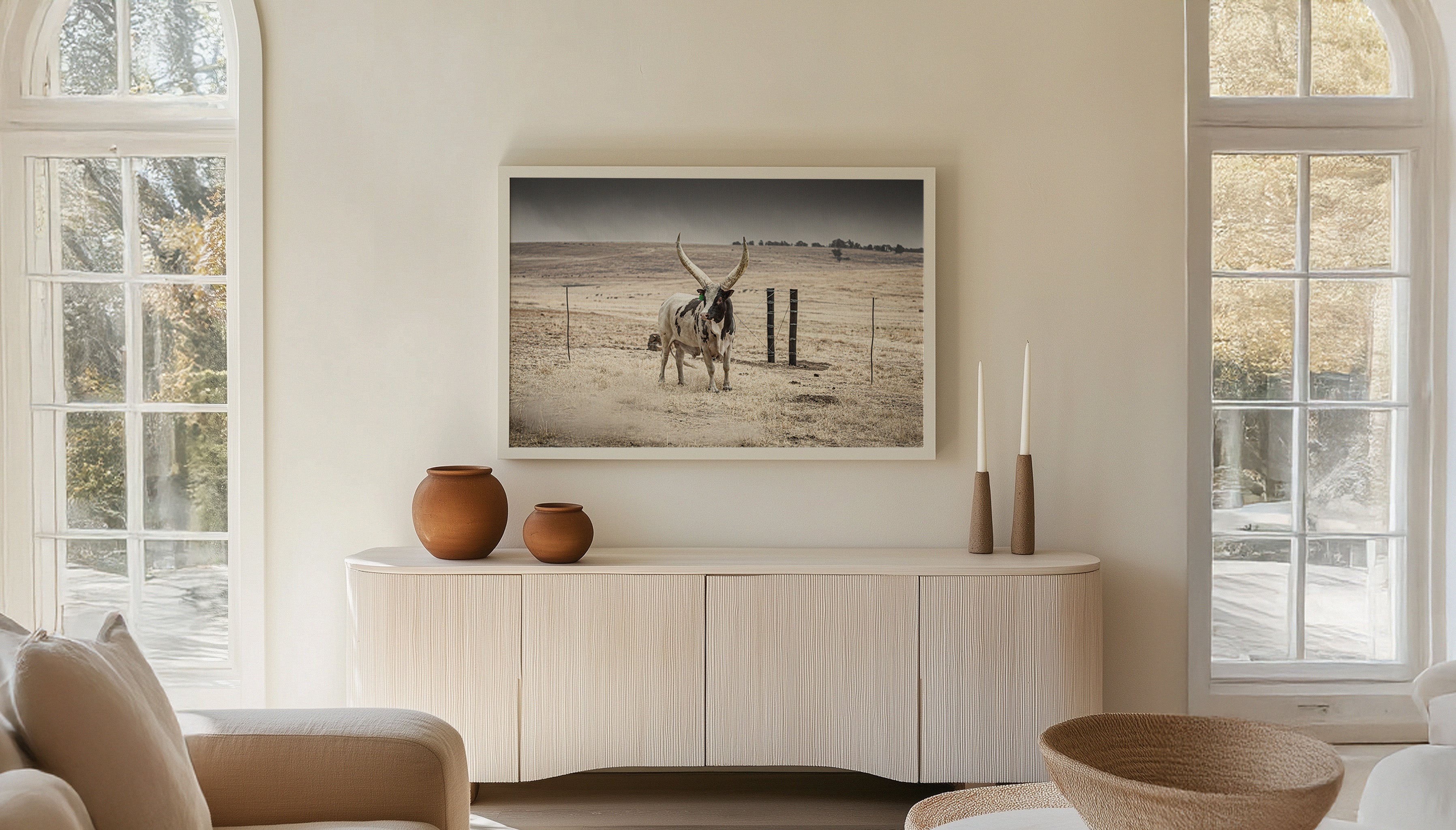 Charles Johnstone's DOZER print from South Africa hangs in a white frame above a Scandi-style side board.