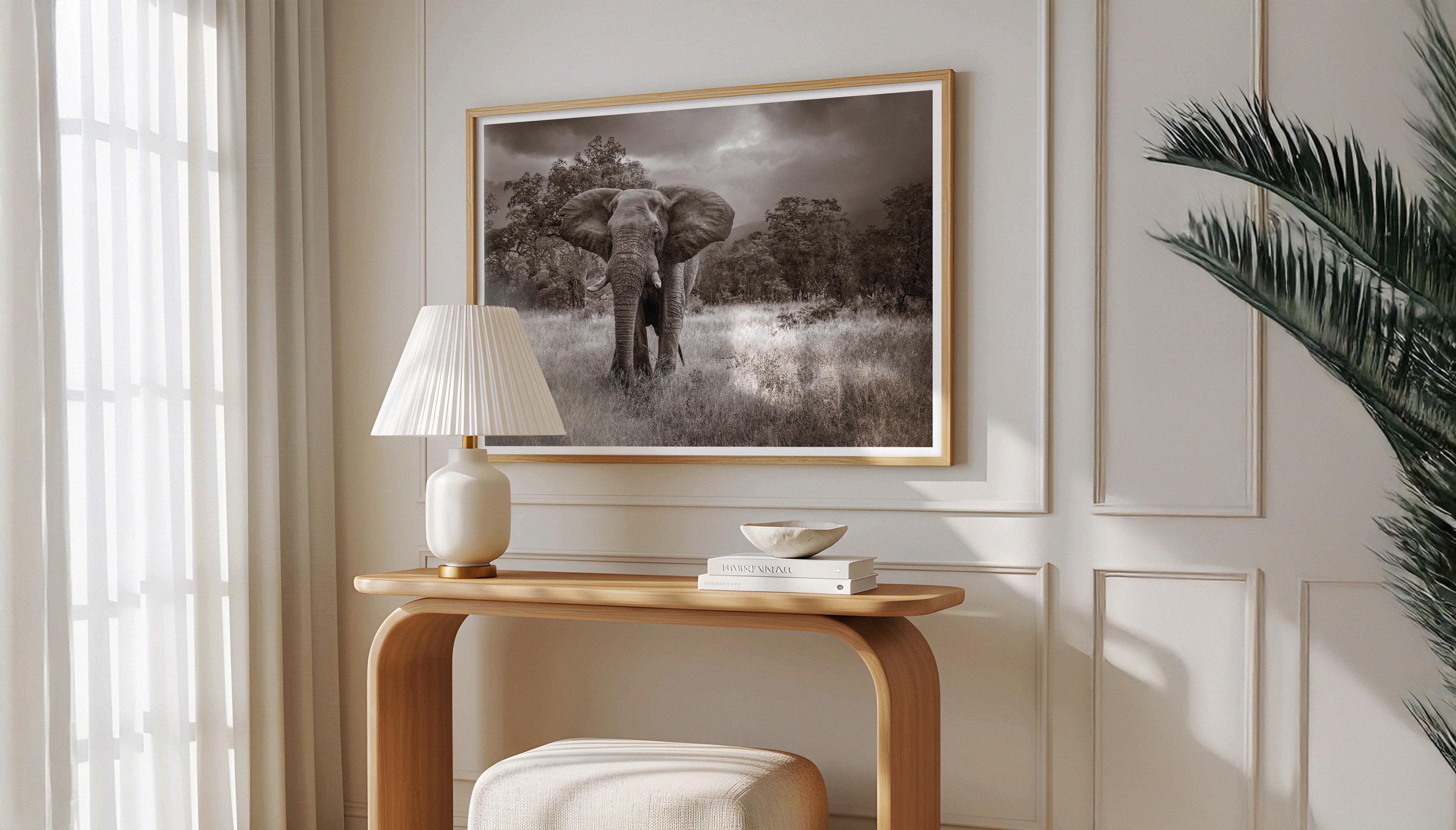 Charles Johnstone's monochrome photography print ELEPHANT in a wooden frame above a Scandi-style desk flanked by green plants.
