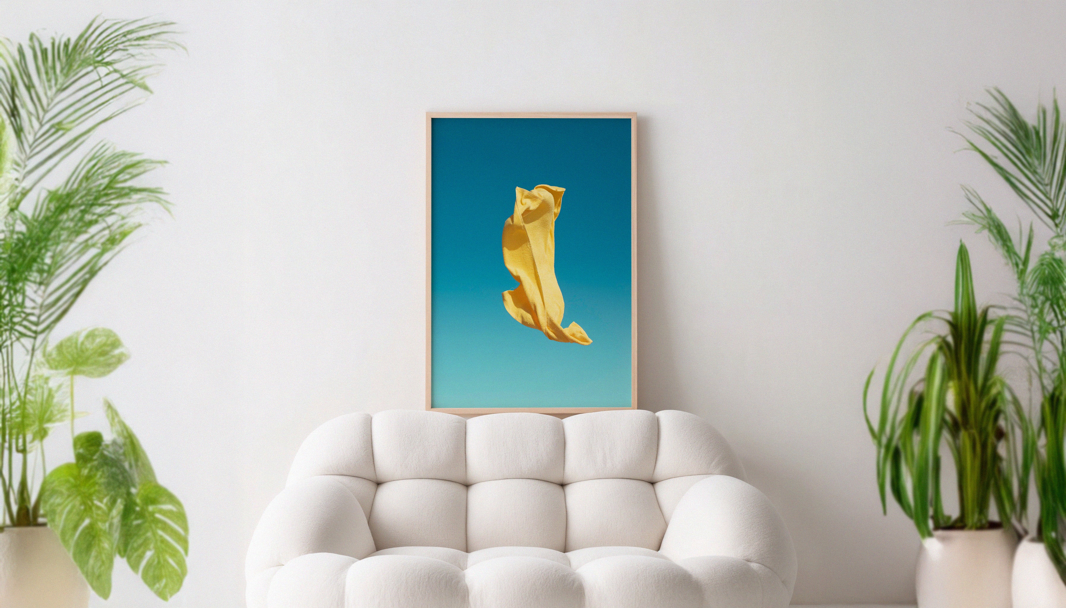 A yellow beach towel gets caught off guard on a windy day in the Algarve with a bright blue sky backdrop. A colourful fine art photography print by Will Bremridge, available exlcusively on The Lost Works.