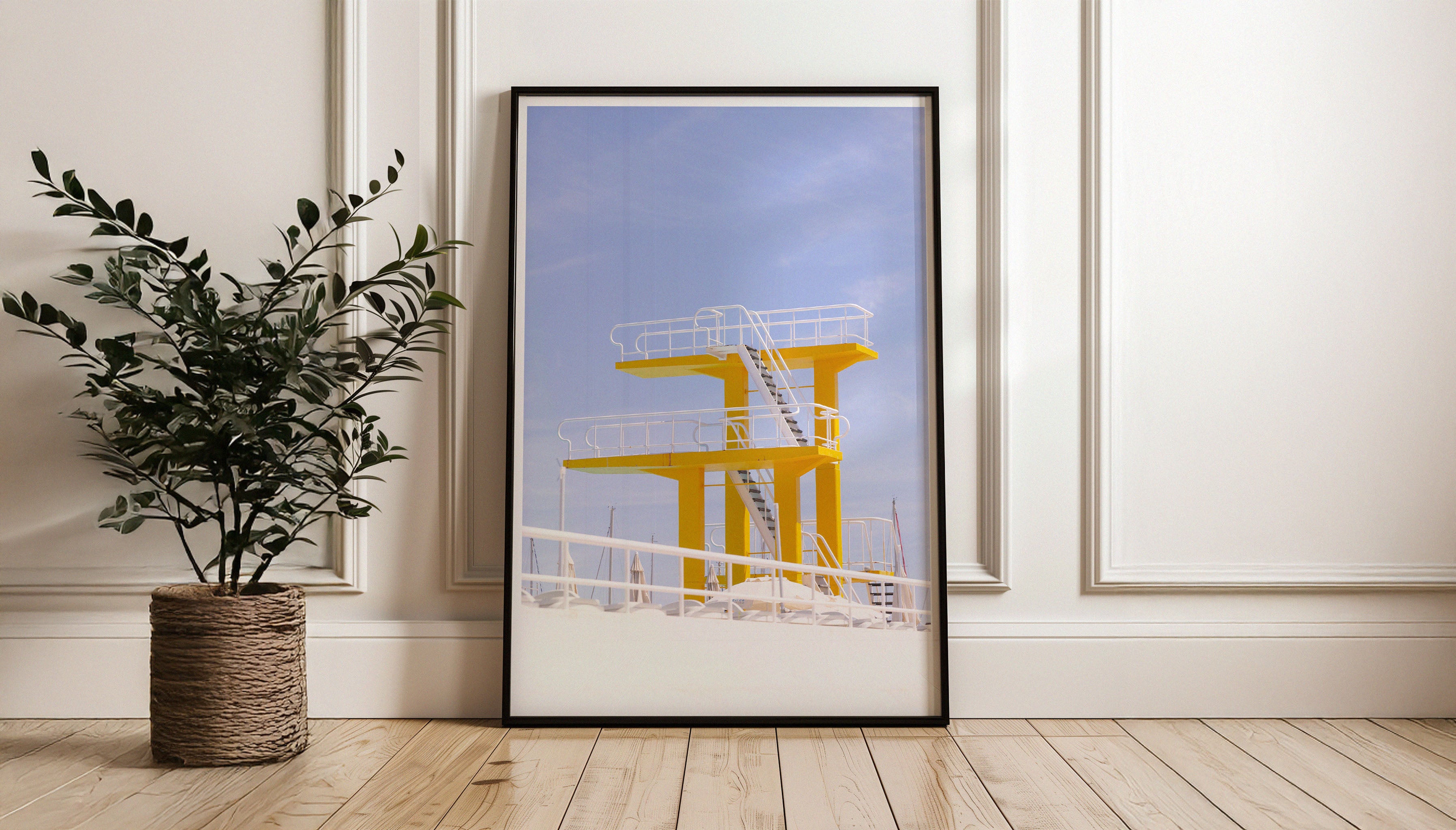 A hotel pool just outside of Lisbon boasts an impressive two-tier diving board, with bright yellow platforms, and white railings to match the wispy clouds in the blue sky. This fine art photography print by Will Bremridge is available to purchase exclusively from The Lost Works.