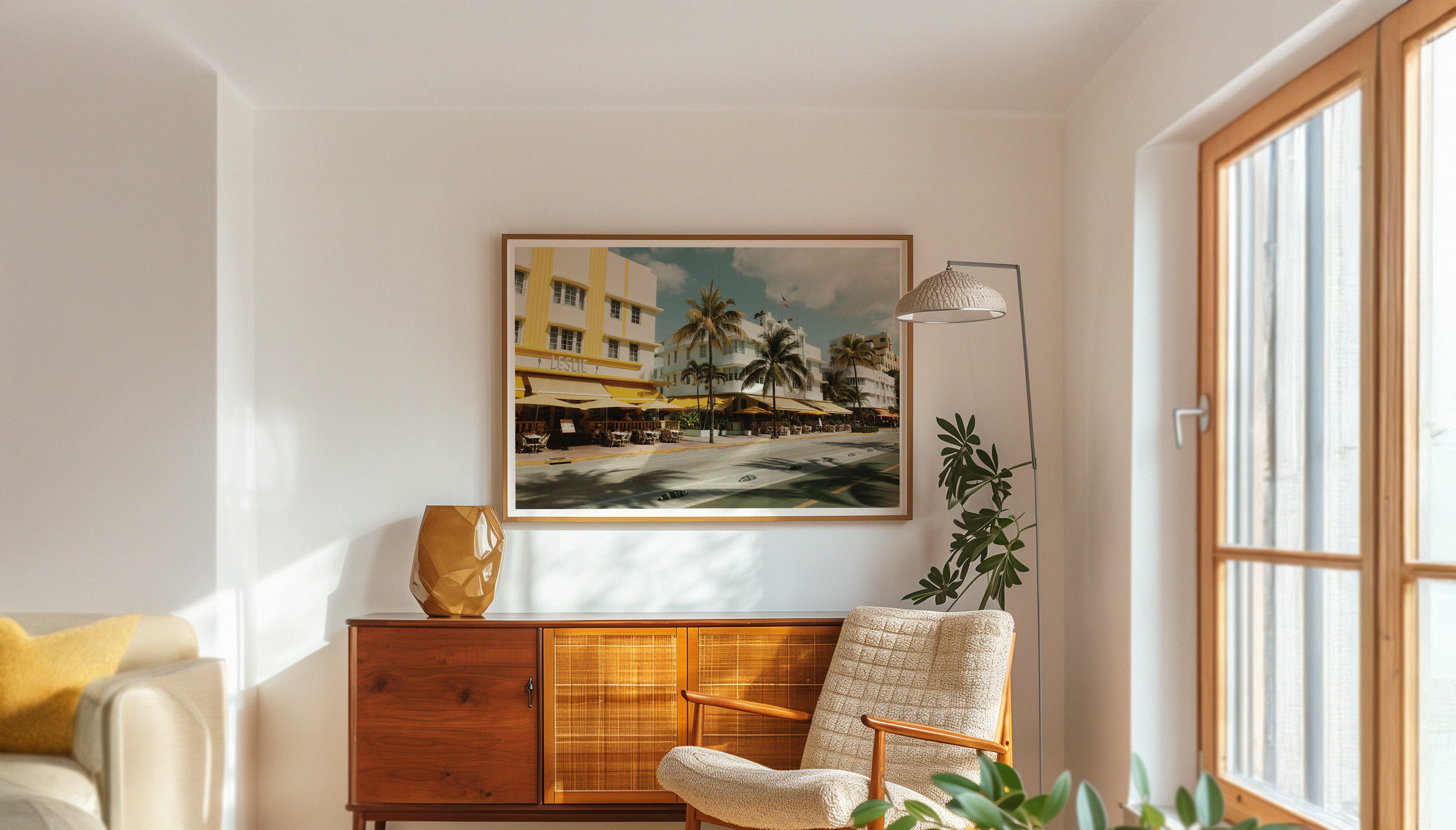 A photograph by Hannes Kläger taken while exploring the Art Deco District in Miami, where palm tree shadows dance across the pastel-coloured buildings that line the street. A piece of wall art showing Miami's authentic vintage charm, available to buy on The Lost Works.