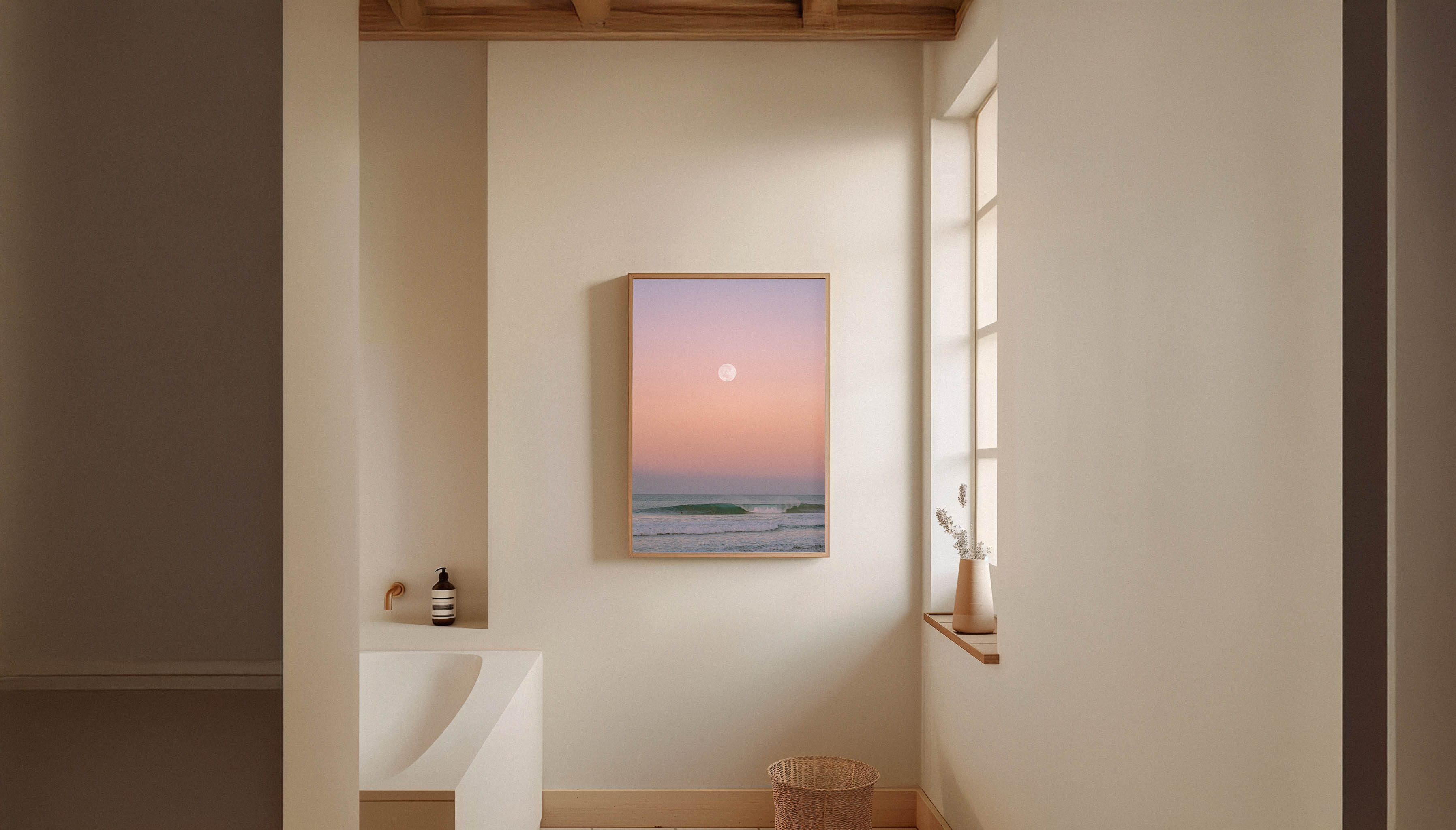 Evie Johnstone's calming MOONLIT SURF, a ready-to-hang photography print shown in a wooden frame hanging in a minimalist, serene bathroom.