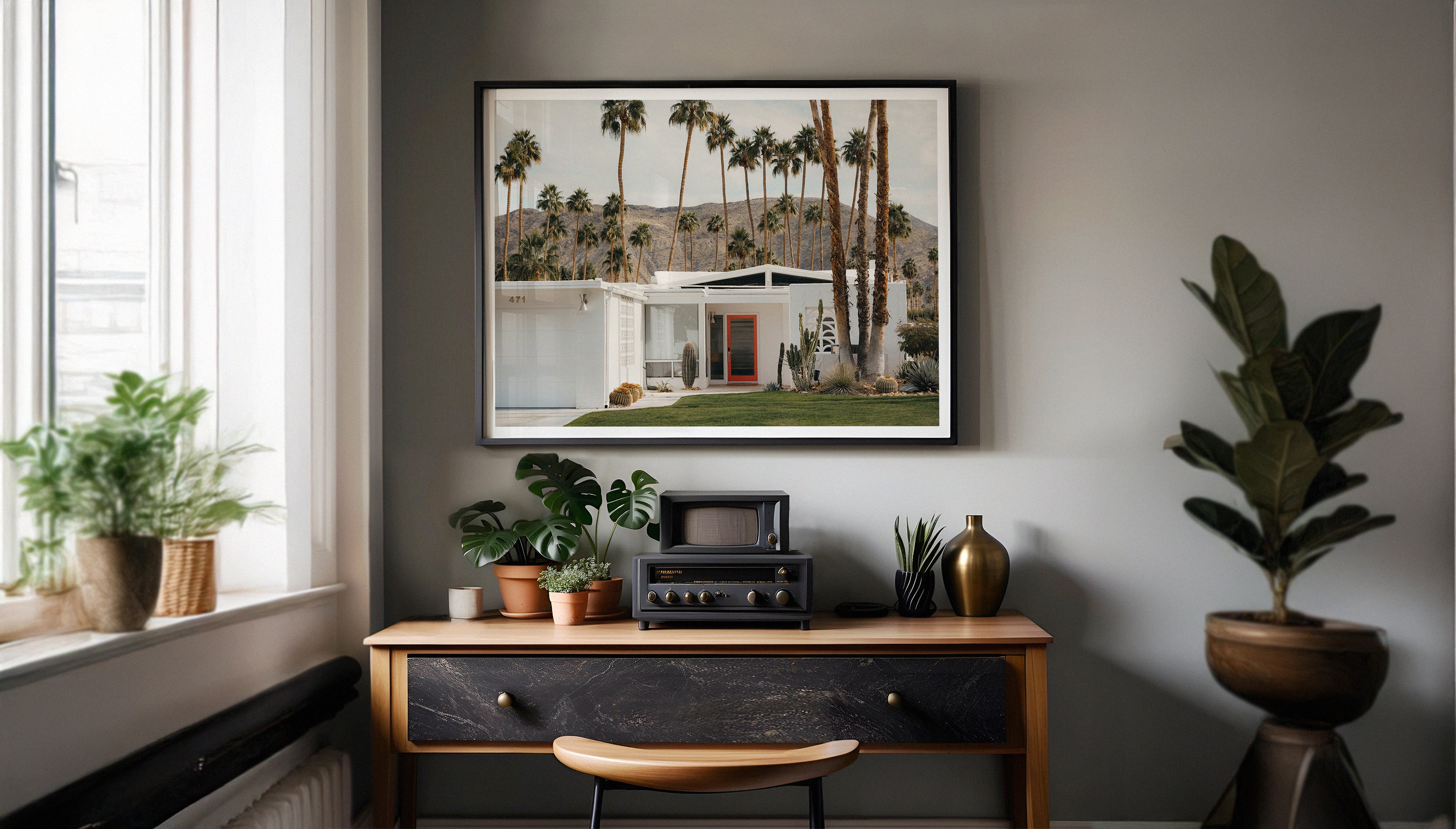 A fine art photography print by Hannes Kläger of white house with a red front door in Palm Springs. It's immaculate garden is filled with cacti, and it has backdrop of palm trees and hills. Available to shop as a ready-to-hang print exclusively on The Lost Works.