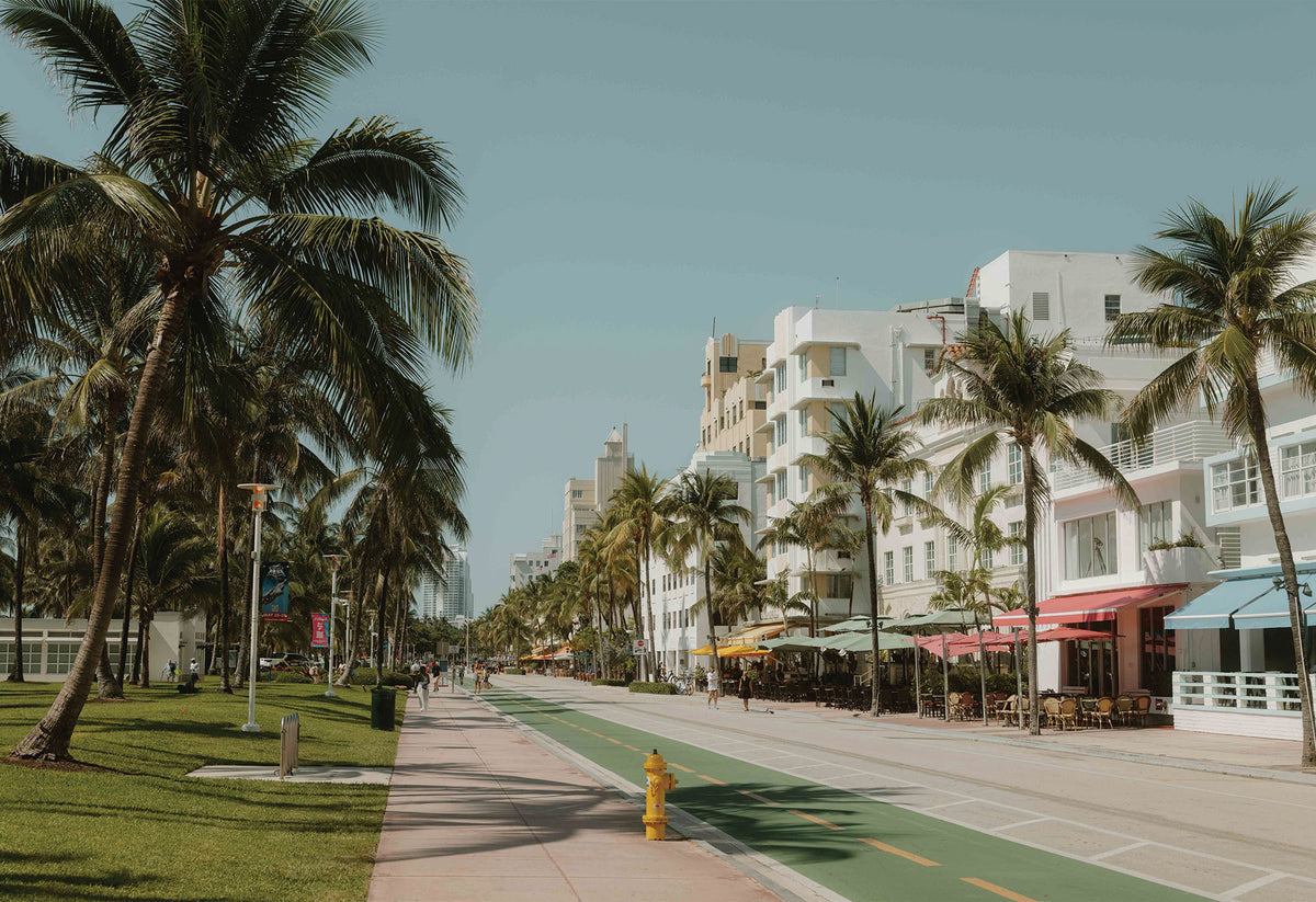 A fine art photography print by Hannes Kläger taken in Miami Beach's Art Deco District. Soft pastel hues, bold geometric patterns and nostalgic architectural details combined with palm trees and blue skies. Available to purchase as wall art from The Lost Works.