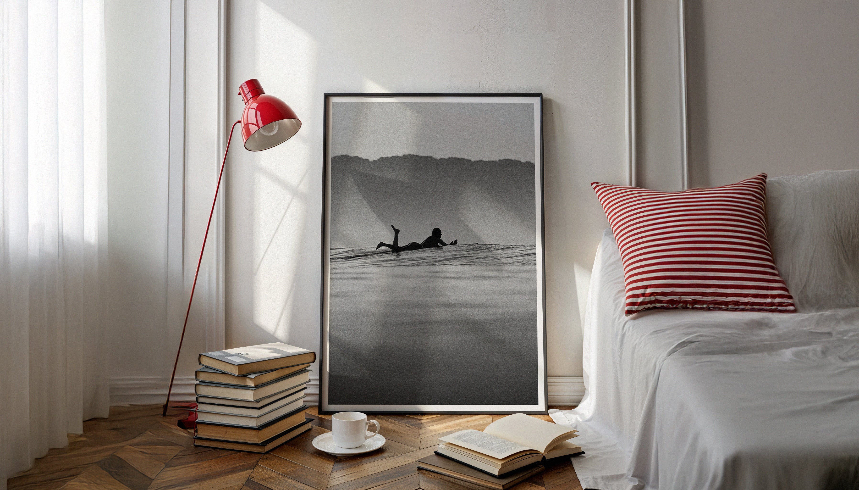 Wide-angle view of framed surfer print displayed beside a striped pillow and floor lamp, showcasing Santa Teresa surf photography by Ez Rivero as elegant home decor.