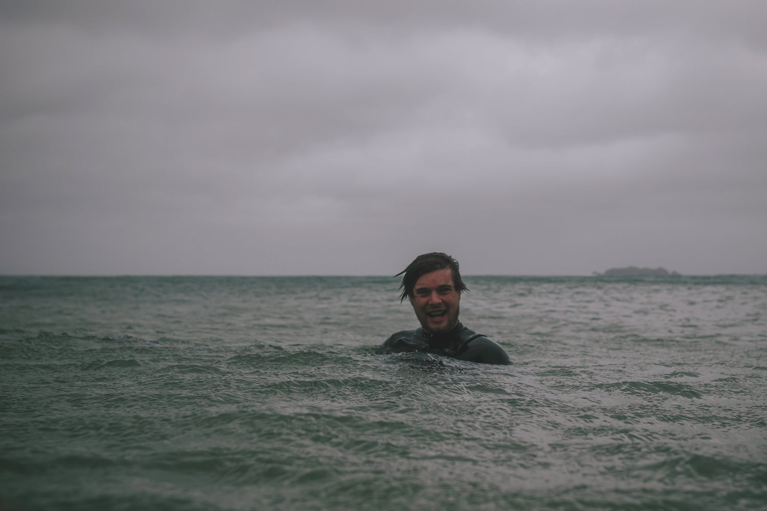 Biography image of Chris Hall in the sea, a photographer on the artist roster of The Lost Works gallery.