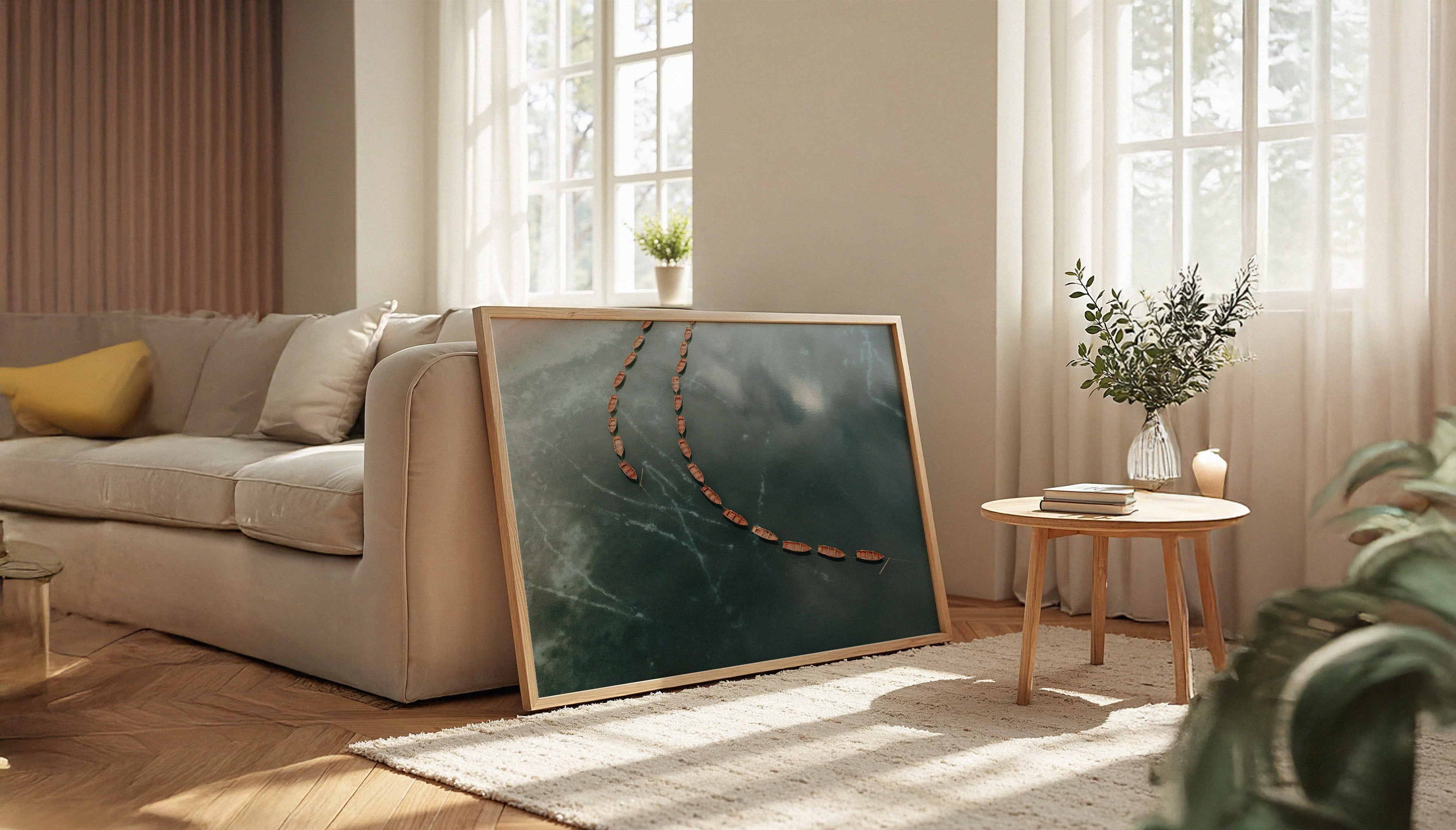 The peaceful travel print by Sam Morris in a wooden frame, depicting the wooden rowboats floating on the still turquoise water of Lago di Braies in the Dolomites.