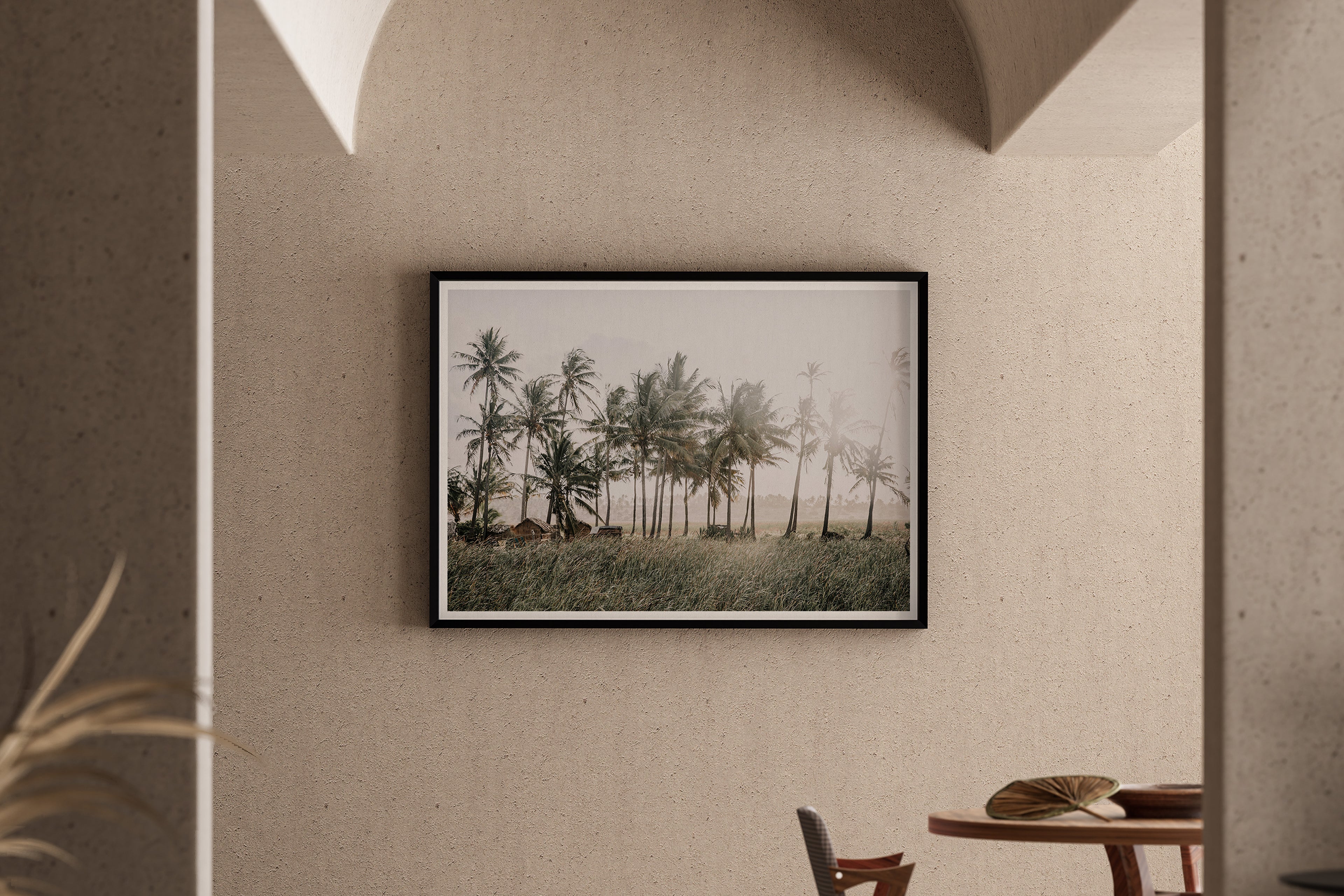 The sun flares through coconut-laden palm trees in a sleepy beachside town in Mozambique. A fine art phtography print by Charles Johnstone, available exclusively on The Lost Works.